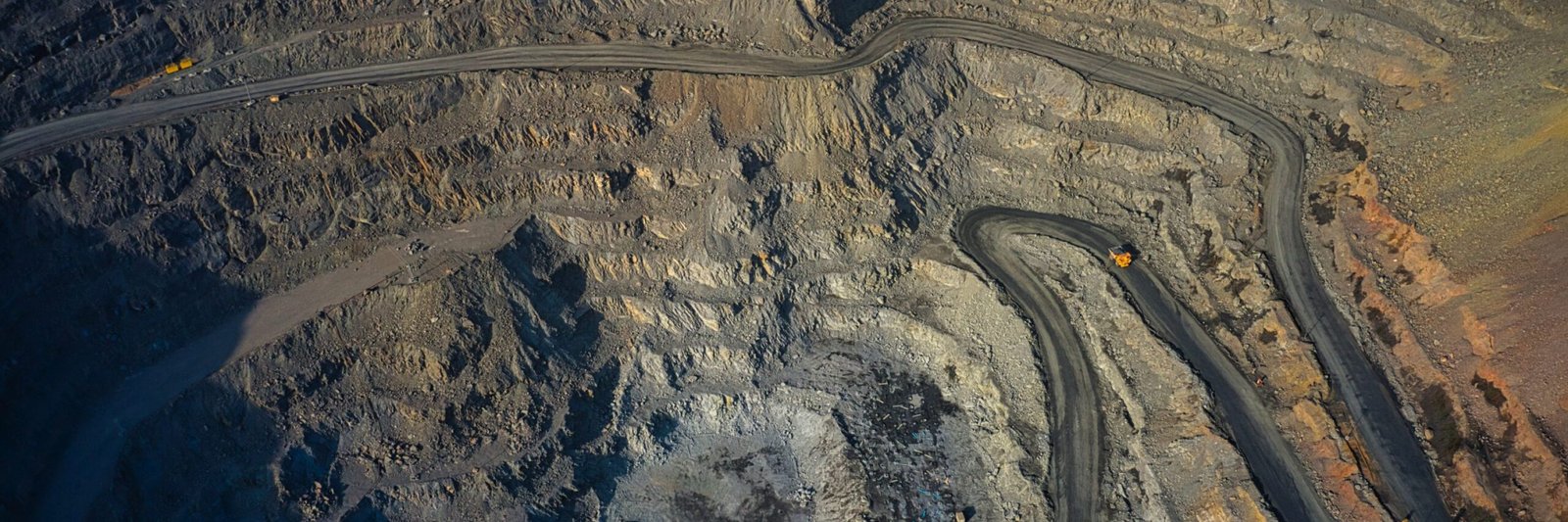 Aerial view of southern mining factory, mine quarry in Ukraine Extraction of minerals with the help of special equipment in the warm evening light in picturesque Ukraine. Aerial panoramic drone shot